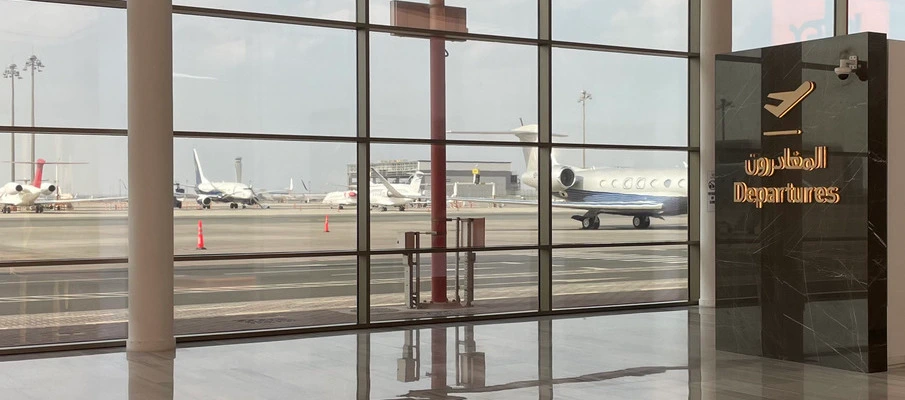 Chauffeur with a name sign in the DXB arrivals hall