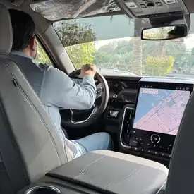 Rent a car with driver – CalibRide SUV and chauffeur helping with luggage.